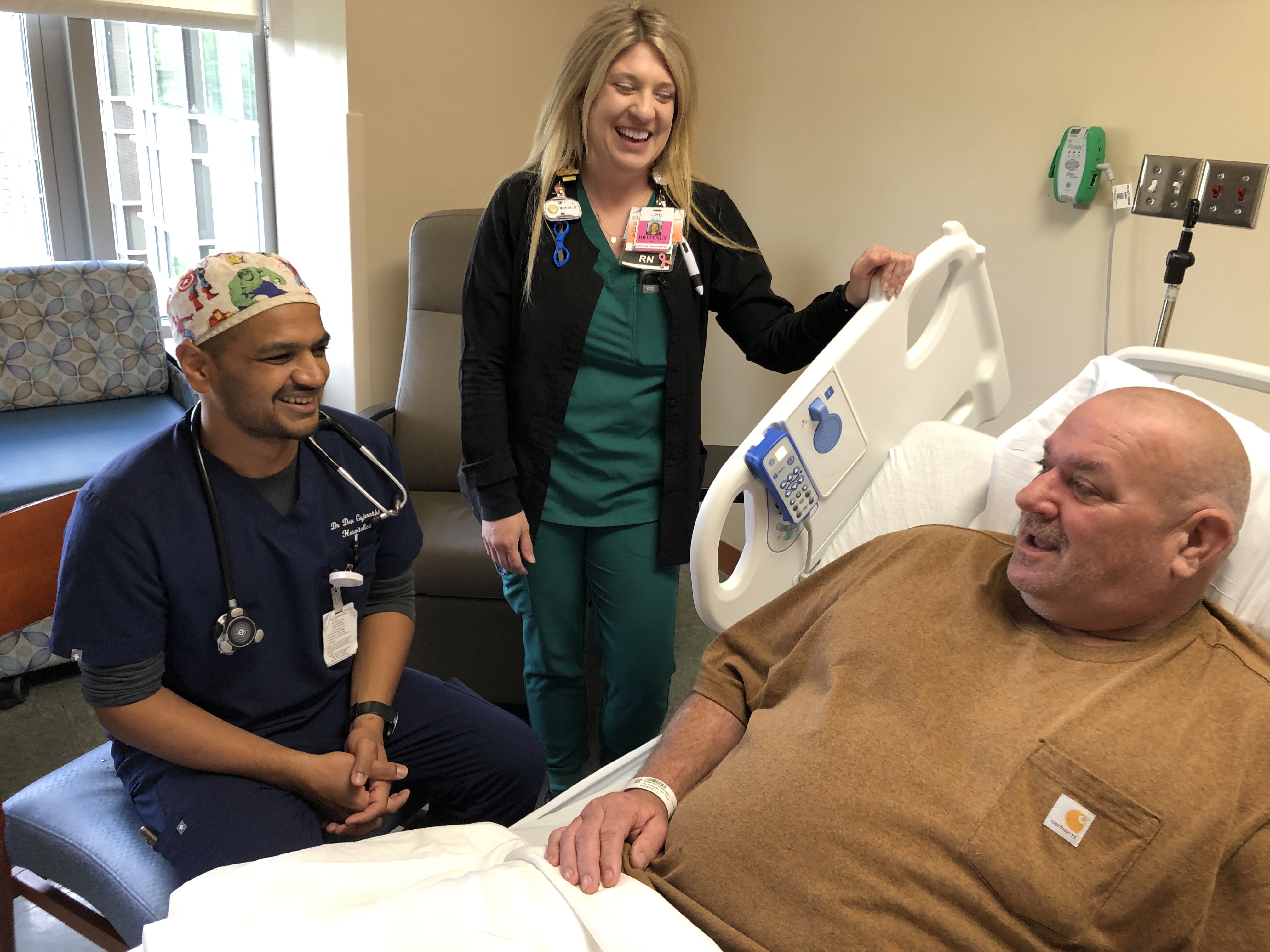 Dr. Devang Gujarathi and Brittney Langdon, RN, share a light moment with one of their patients.