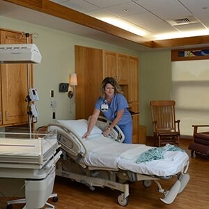 Nurse adjusting bed in a birthing suite