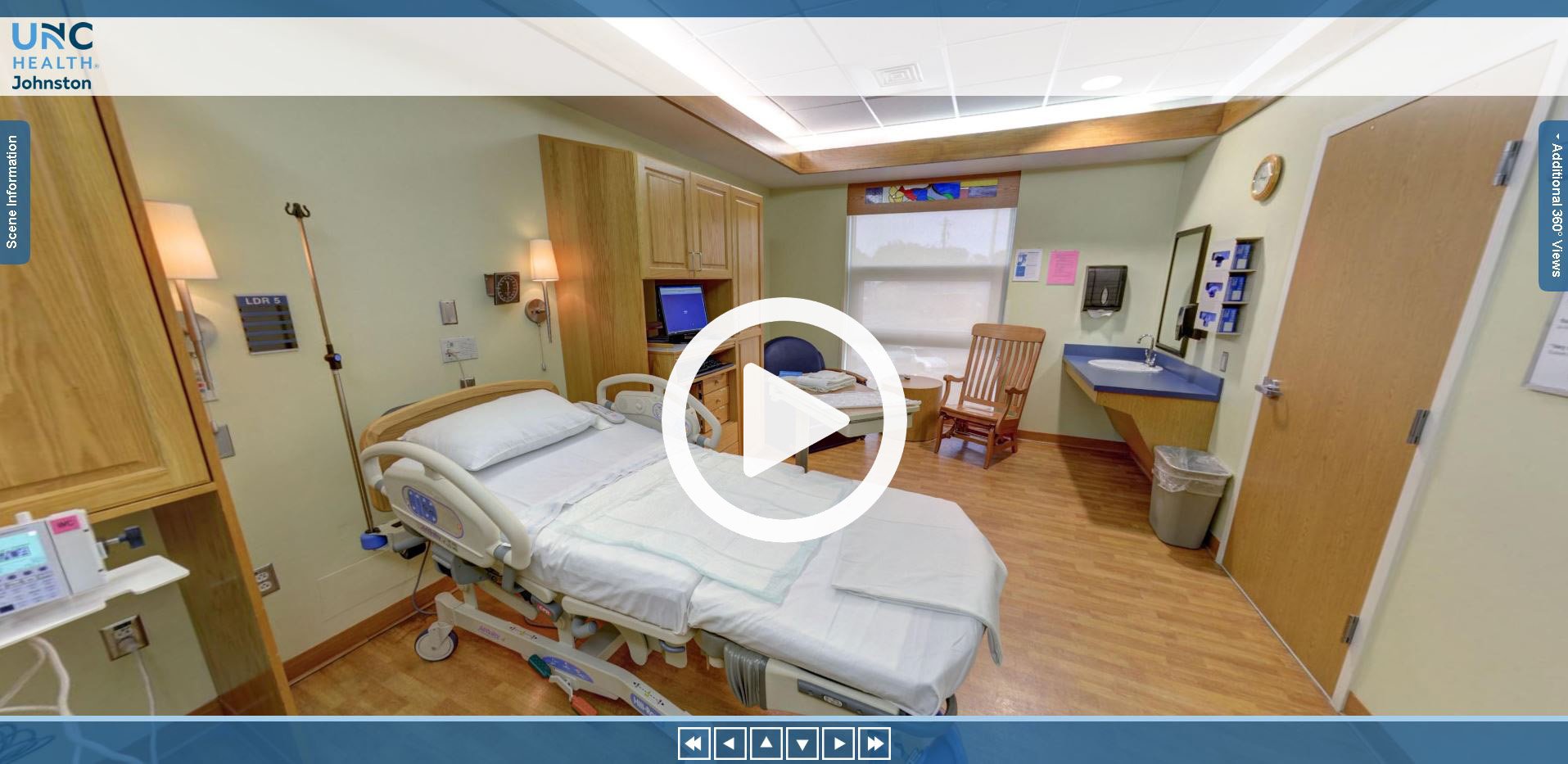 Delivery room with table, chairs, and delivery bed