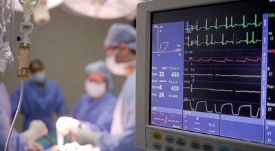 monitor with surgeons in background
