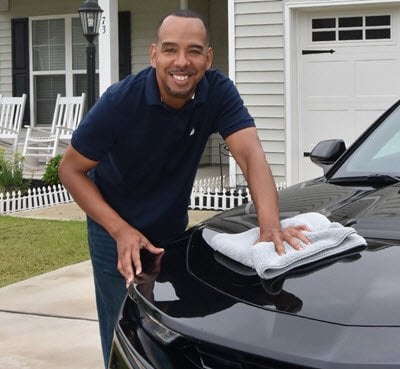 Alonzo James washing his car
